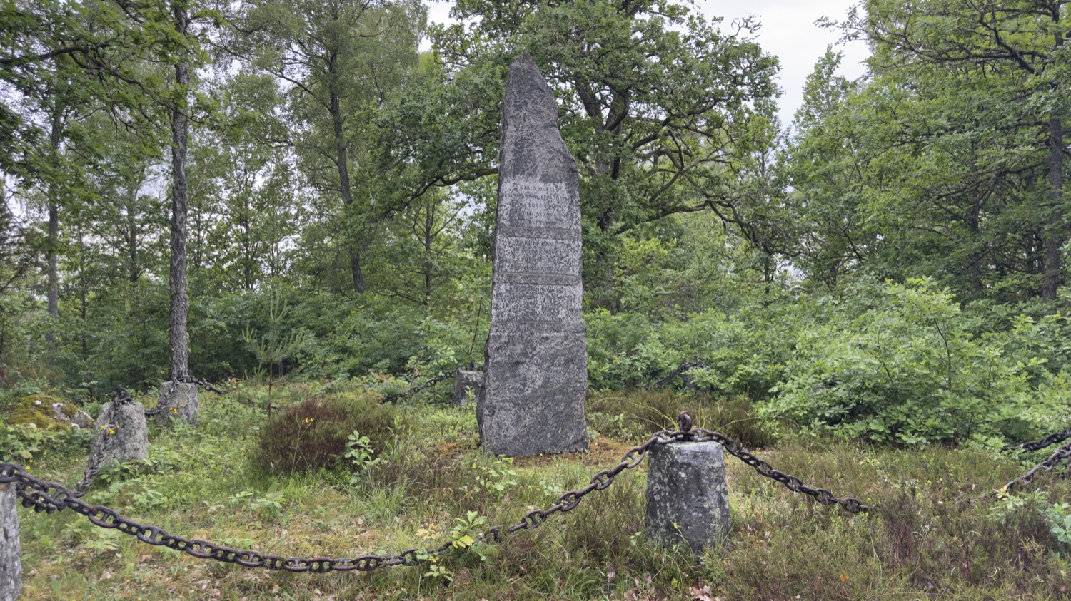 Chain-fenced memorial site of the Battle of Sibbarp under oak trees